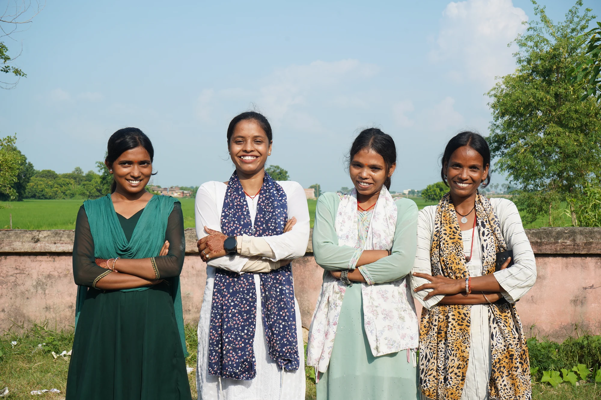 Four women photographed together outdoors